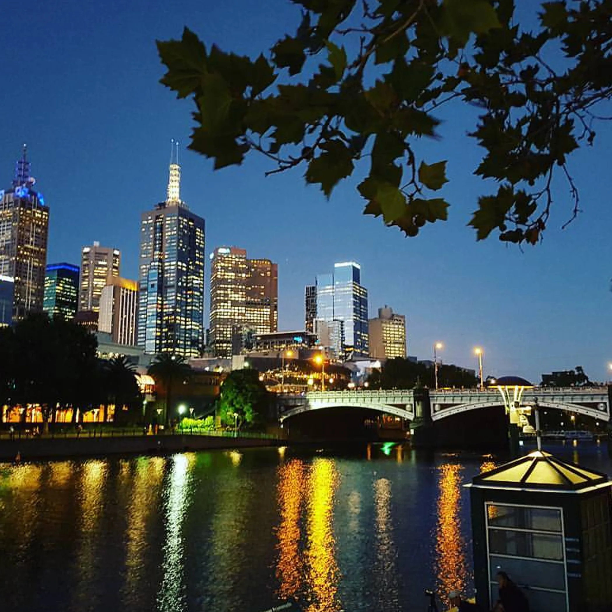 friends walking along yarra river summer evening