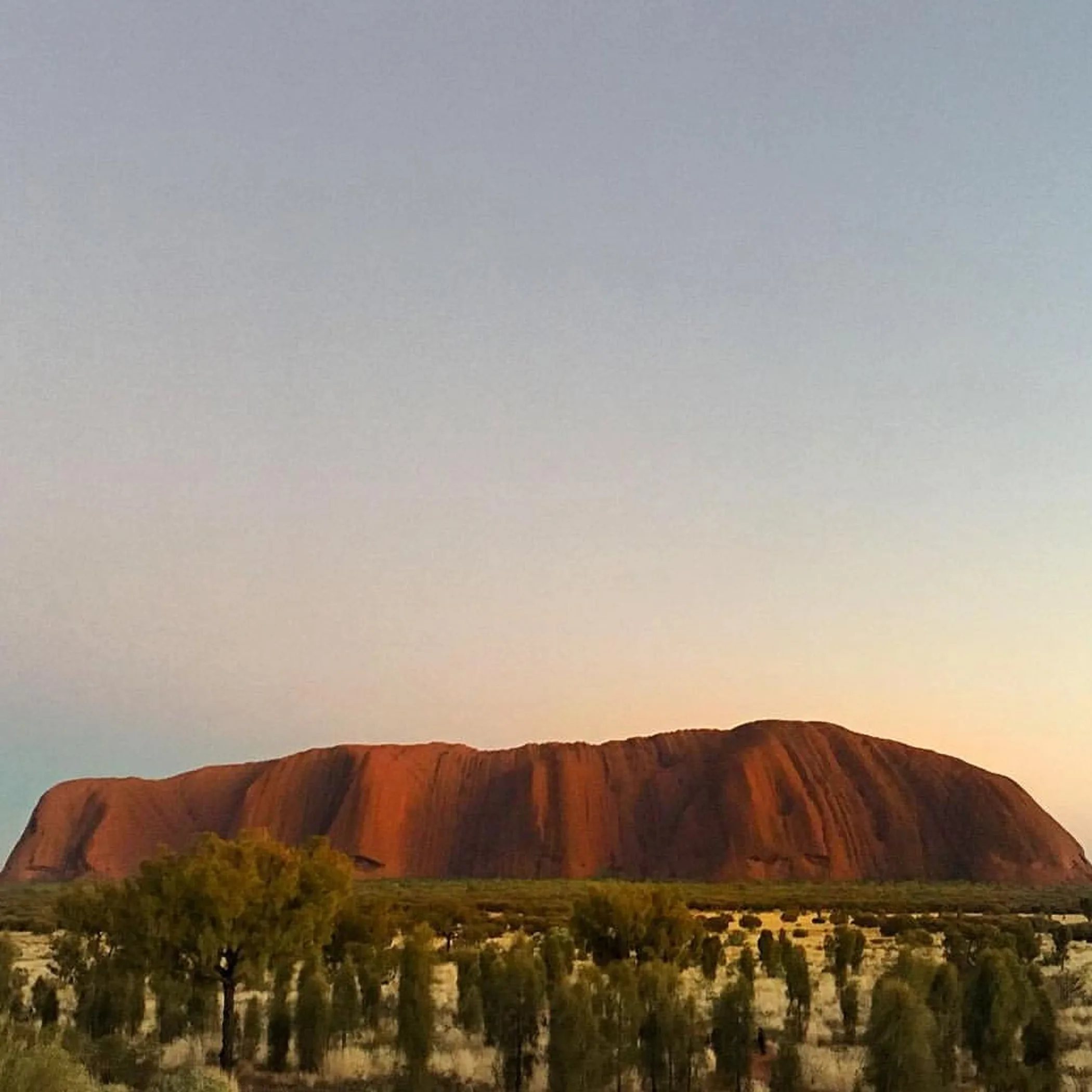 tourists walking on marked uluru trail